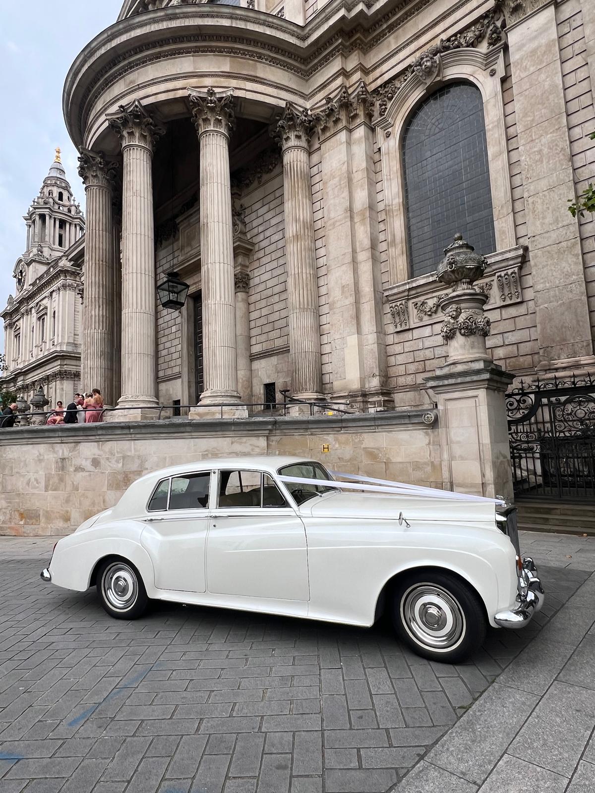 chauffeur opening door Bentley S3 wedding car hire