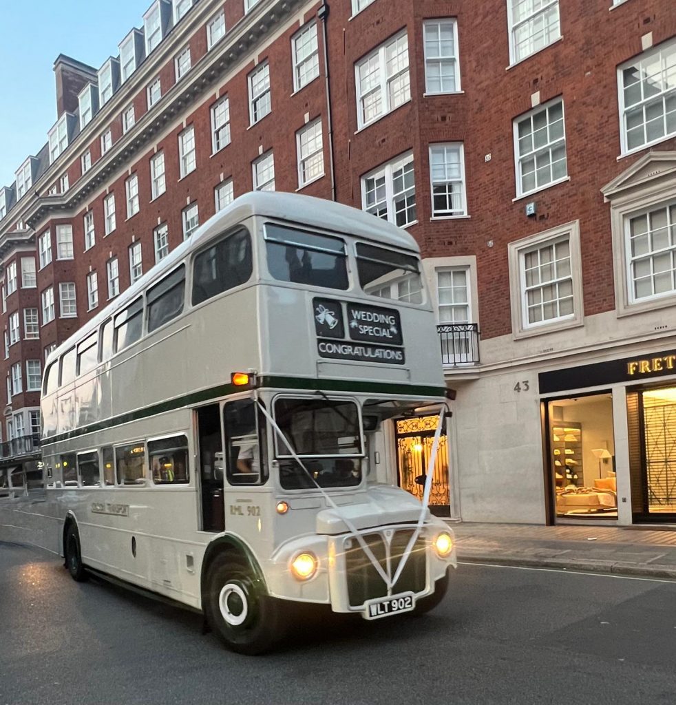 Vintage Routemaster bus interior with classic seating and wooden stairs