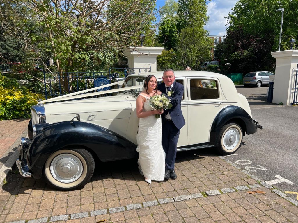 Chauffeur opening door wedding car hire London service