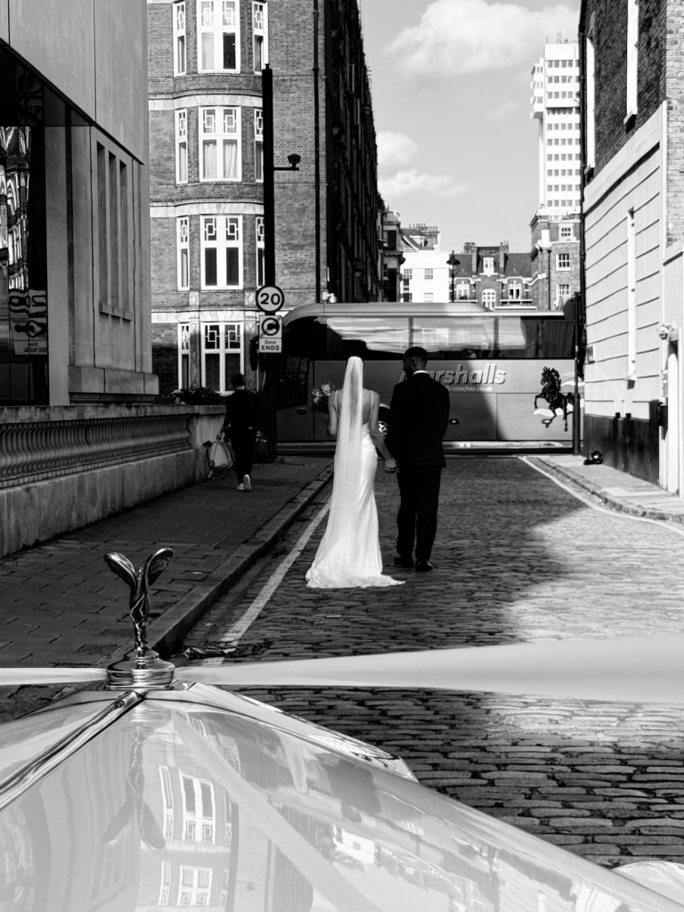 Bride arriving in vintage wedding car at Marylebone Town Hall London