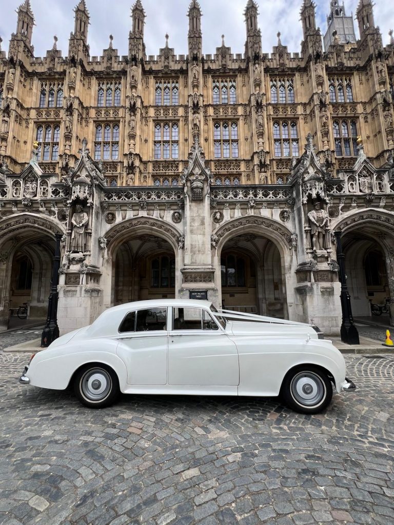 Wedding chauffeur service Westminster opening car door for bride