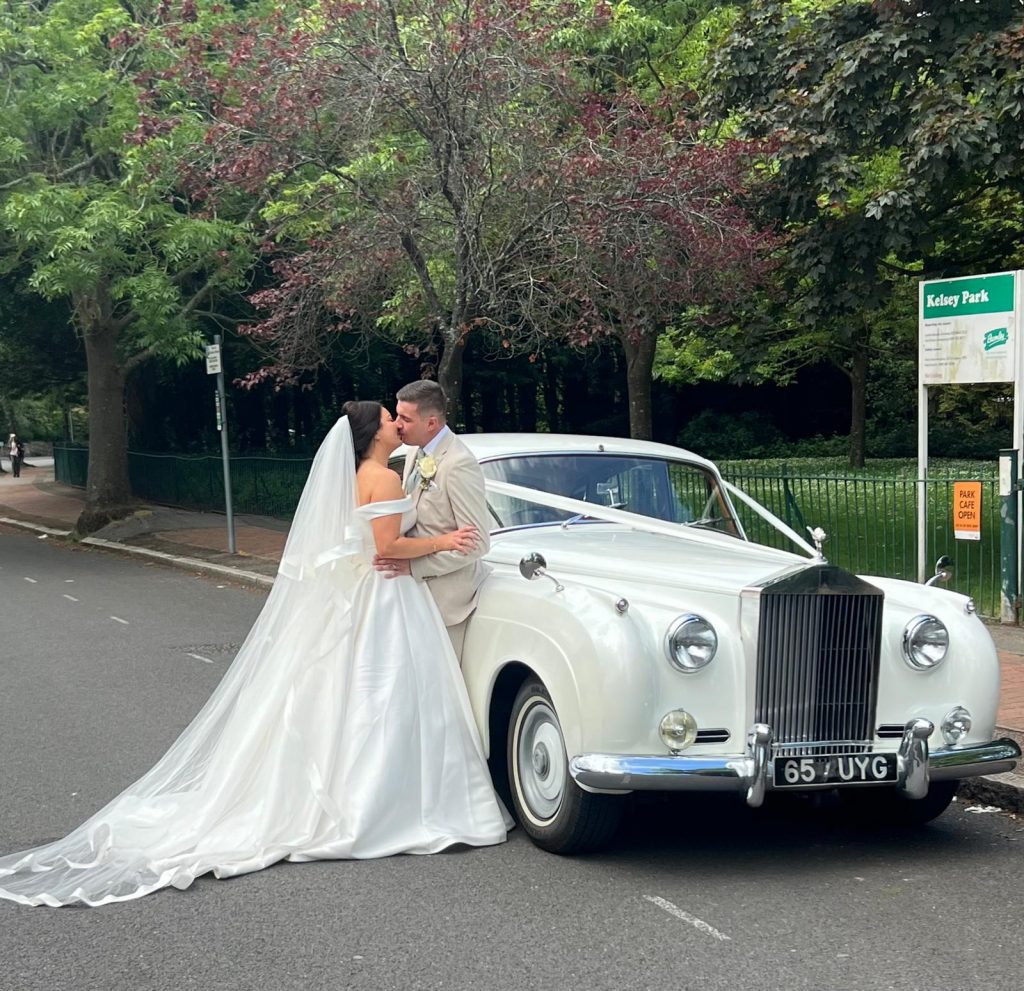 Modern Mercedes wedding car hire with chauffeur at wedding ceremony