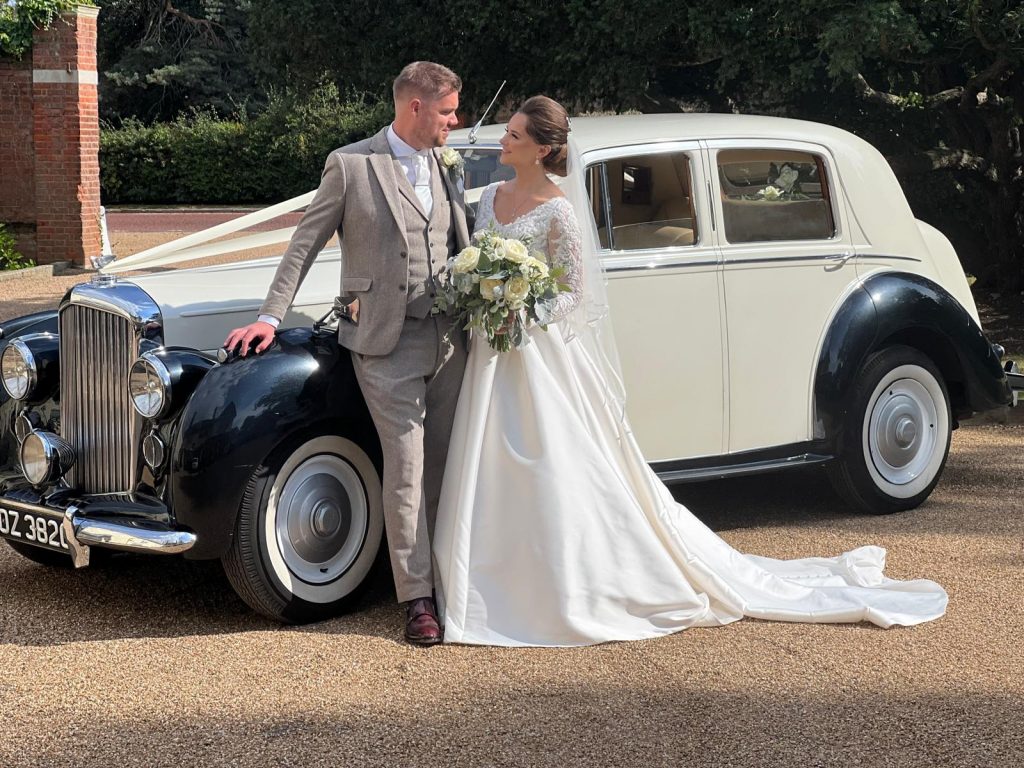 Classic wedding car hire with ribbons and wedding decorations